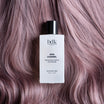 BDK Parfums Hair Perfume Gris Charnel flacon sur cheveux lilas