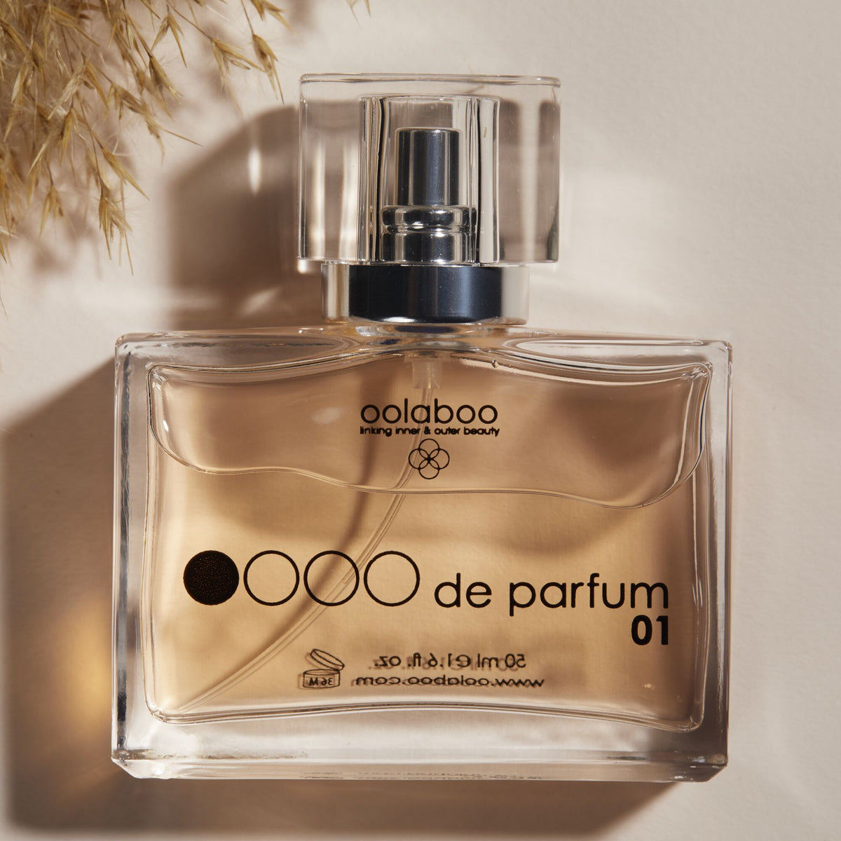 Oolaboo OOOO de Parfum 01 flacon en gros plan sous une lumière chaude